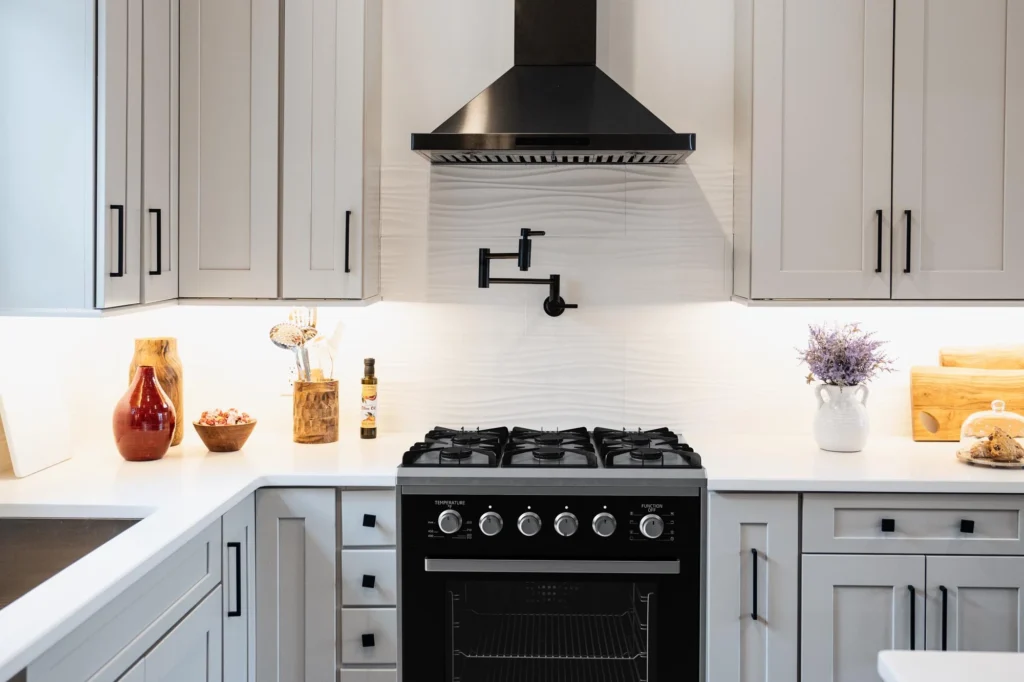 Kitchen remodeled with custom cabinetry, range, and hood by Keen Improvements.