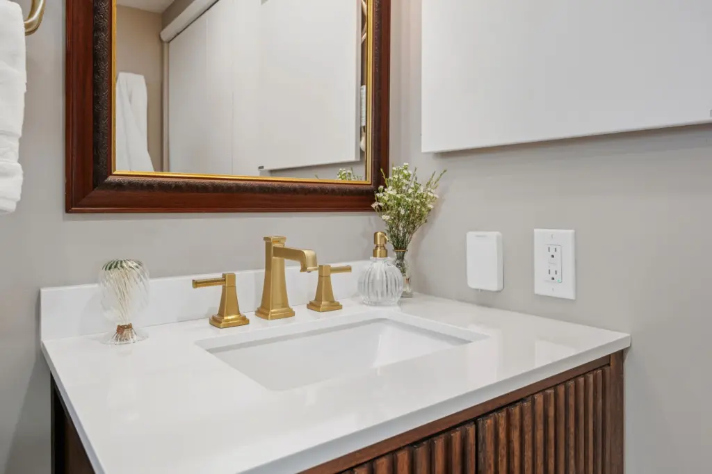 Remodeled bathroom with gold faucet pleasant valley ny by Keen Improvements.